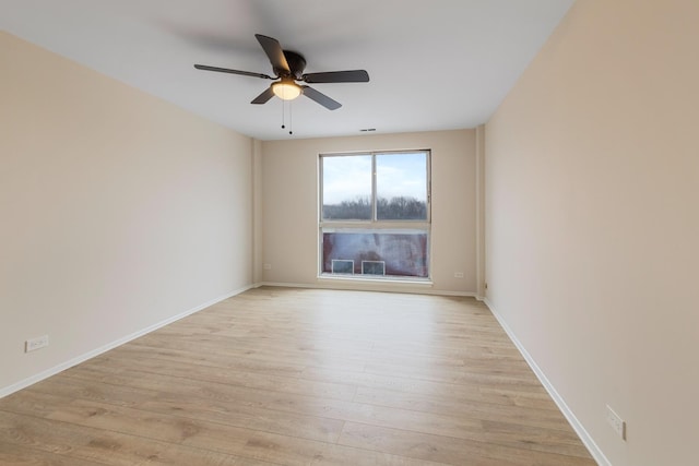 empty room with ceiling fan and light wood-type flooring