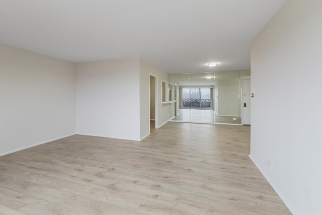 empty room with light hardwood / wood-style flooring