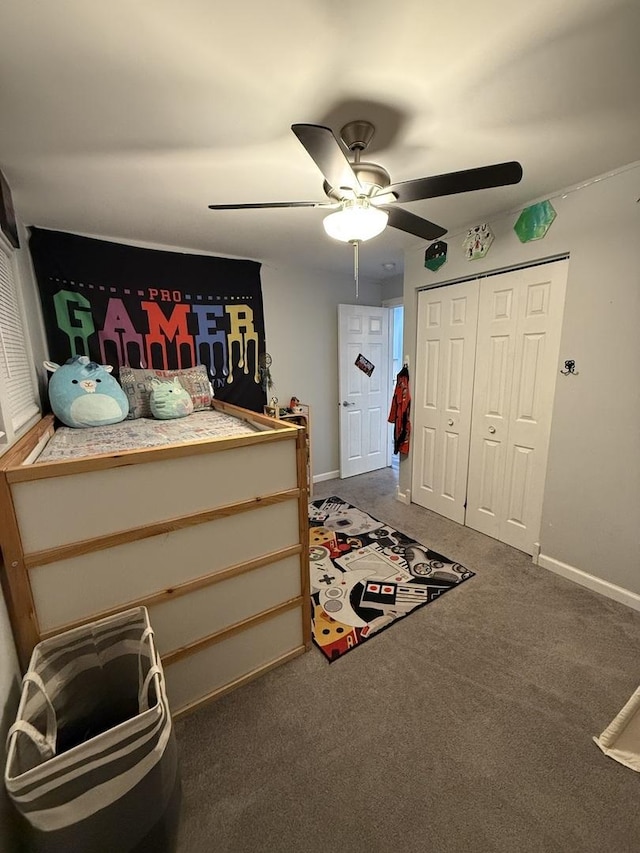 carpeted bedroom with ceiling fan and a closet