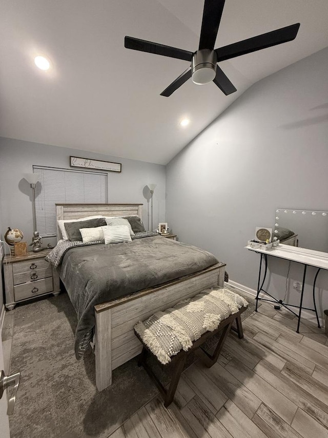 bedroom featuring ceiling fan, lofted ceiling, and light hardwood / wood-style floors