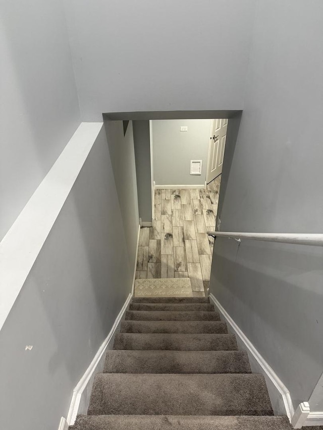 stairs featuring wood-type flooring