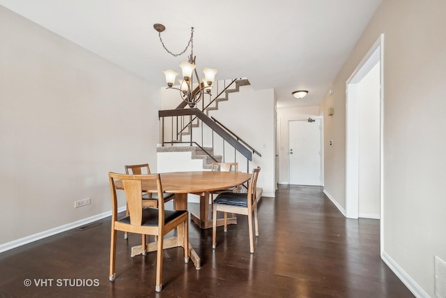 dining space with an inviting chandelier and dark wood-type flooring