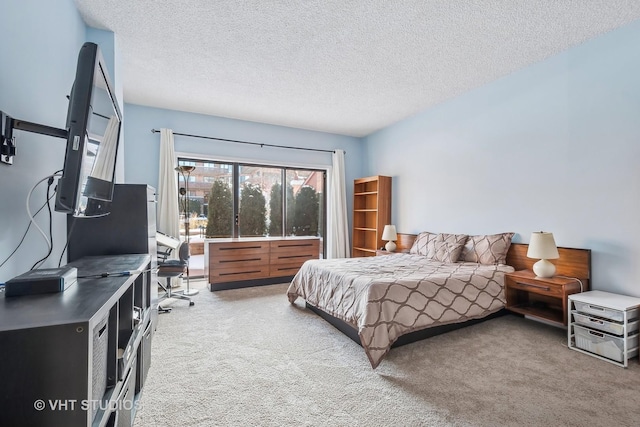 bedroom featuring carpet flooring and a textured ceiling