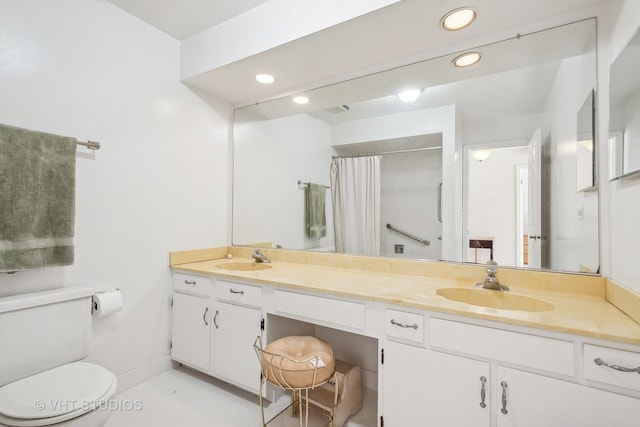 bathroom featuring curtained shower, vanity, and toilet