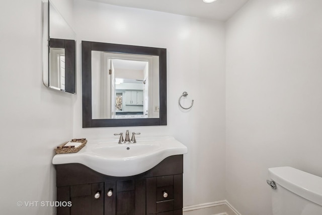 bathroom featuring toilet and vanity