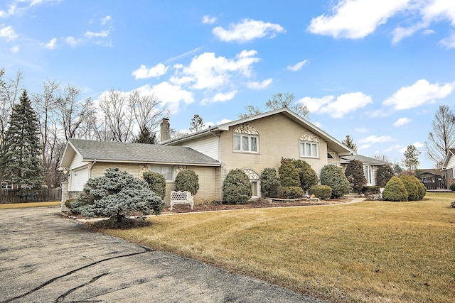 view of front facade featuring a garage and a front lawn