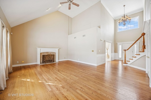 unfurnished living room with light wood-style floors, stairs, ornamental molding, and a tile fireplace