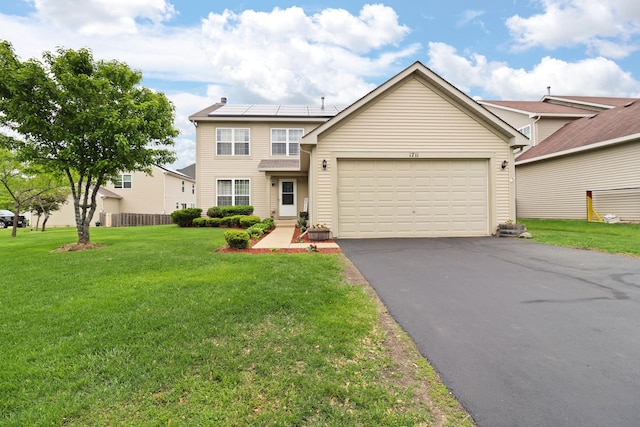 1711 Fallbrook Dr, Hampshire, IL 60140 - traditional-style home with asphalt driveway, a garage, and a front yard