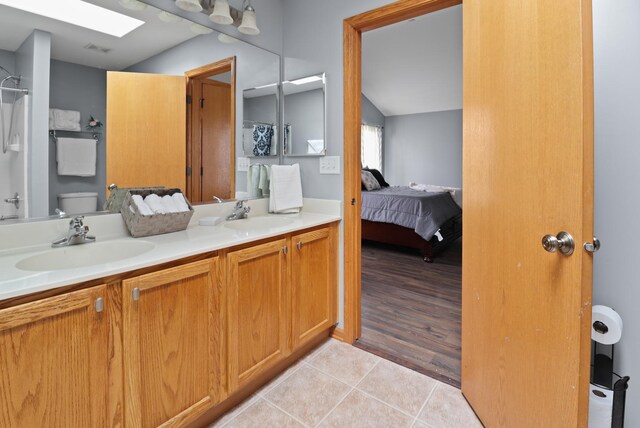 1711 Fallbrook Dr, Hampshire, IL 60140 - ensuite bathroom featuring double vanity, a shower, tile patterned flooring, toilet, and lofted ceiling
