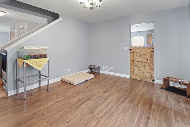 1711 Fallbrook Dr, Hampshire, IL 60140 - sitting room featuring wood finished floors, a chandelier, and baseboards