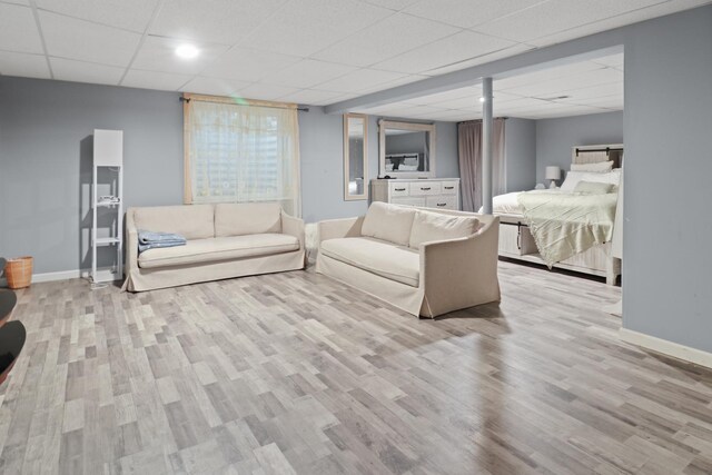 1711 Fallbrook Dr, Hampshire, IL 60140 - living room featuring a drop ceiling, baseboards, and wood finished floors