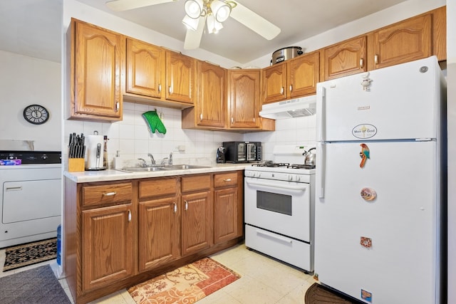 kitchen featuring sink, tasteful backsplash, ceiling fan, white appliances, and washer / clothes dryer