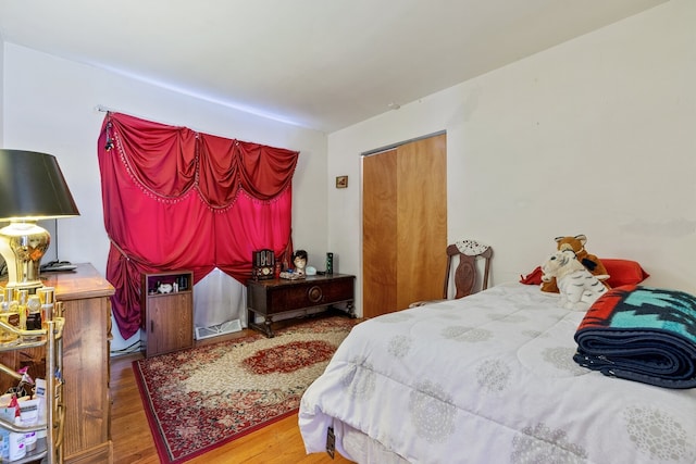 bedroom with hardwood / wood-style floors