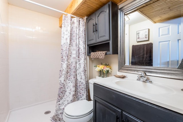 bathroom featuring vanity, toilet, and walk in shower