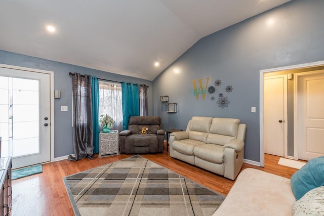 living room featuring lofted ceiling and hardwood / wood-style floors