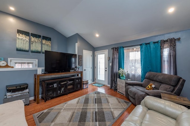 living room featuring hardwood / wood-style flooring and vaulted ceiling