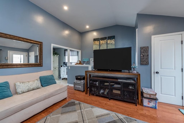 living room with hardwood / wood-style flooring and lofted ceiling