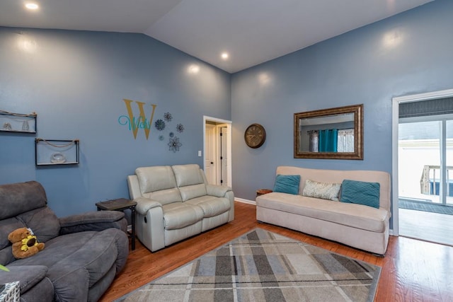 living room with lofted ceiling and hardwood / wood-style flooring