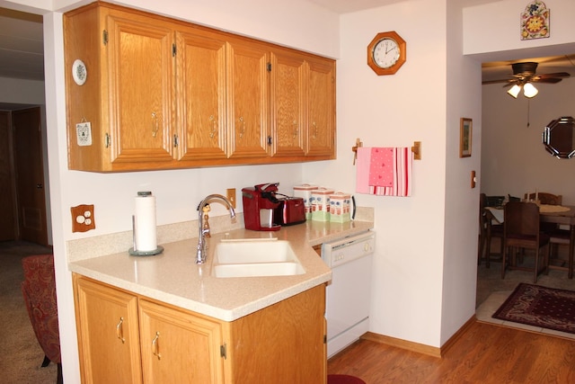 kitchen featuring hardwood / wood-style flooring, ceiling fan, white dishwasher, and sink