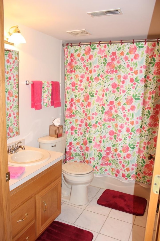 full bathroom with vanity, shower / tub combo with curtain, tile patterned floors, and toilet