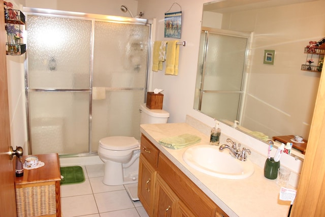 bathroom featuring tile patterned flooring, vanity, and walk in shower