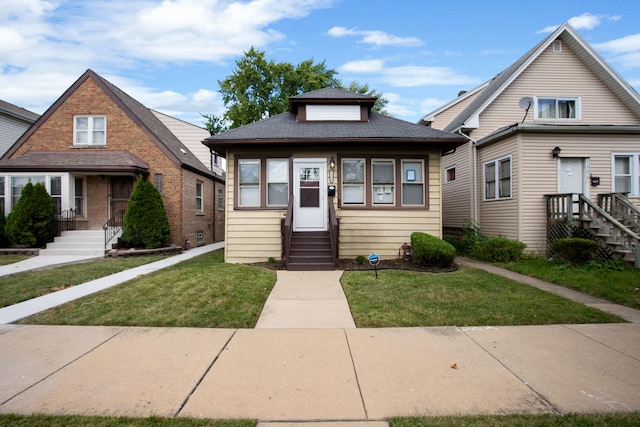 bungalow-style home featuring a front lawn