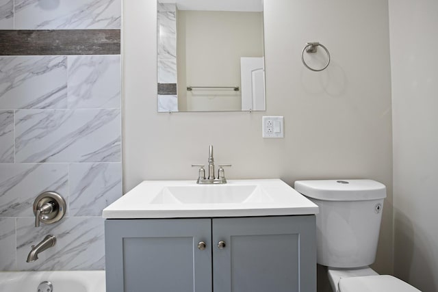 full bathroom with vanity, toilet, and tiled shower / bath combo