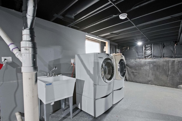 laundry room with independent washer and dryer and sink