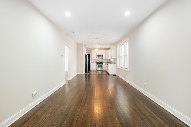 unfurnished living room featuring dark hardwood / wood-style floors