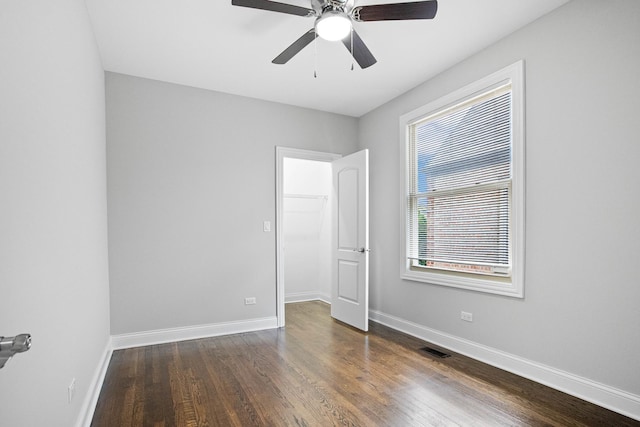 unfurnished room with ceiling fan and dark hardwood / wood-style floors