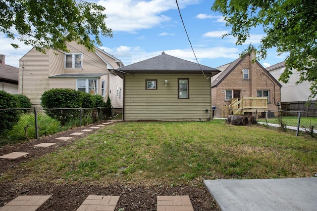 rear view of house with a lawn