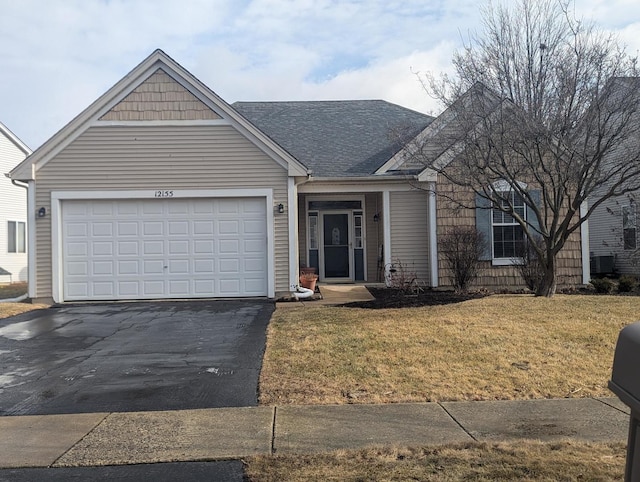 ranch-style house with a garage and a front lawn