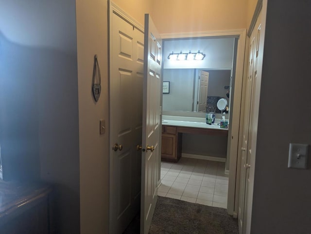 bathroom with tile patterned flooring and vanity