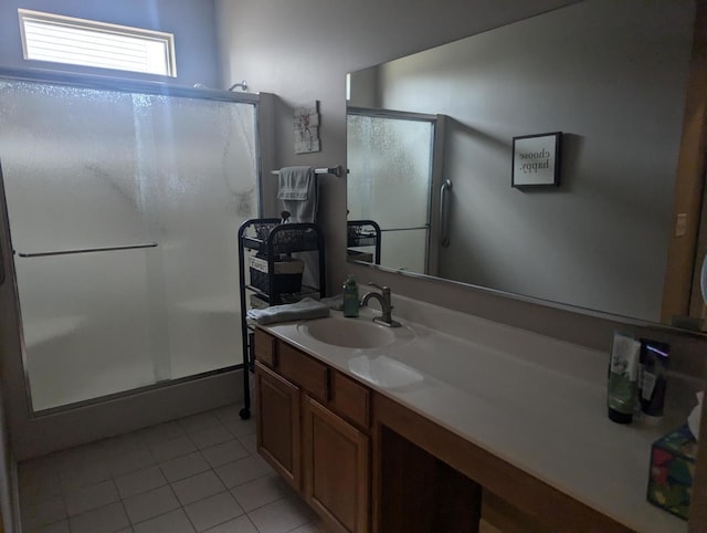 bathroom featuring vanity, tile patterned floors, and a shower with door