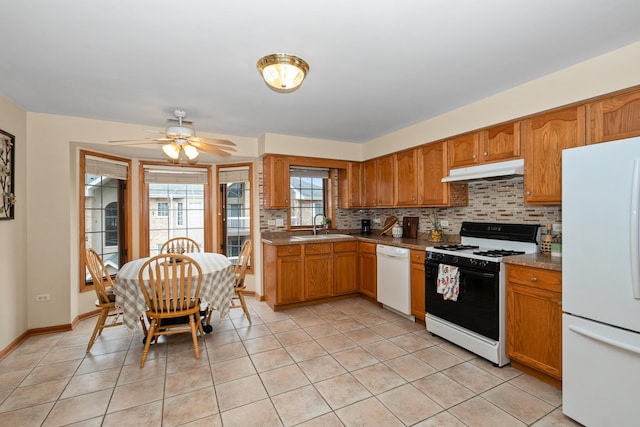 kitchen featuring light tile patterned floors, white appliances, sink, ceiling fan, and tasteful backsplash