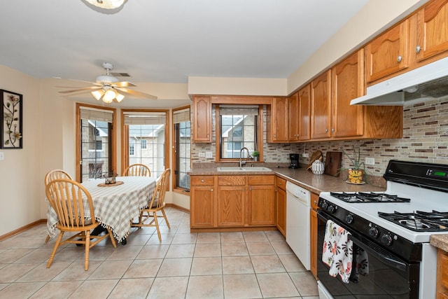 kitchen with sink, range with gas cooktop, light tile patterned floors, dishwasher, and backsplash