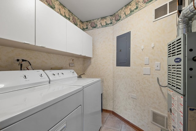 laundry room with cabinets, separate washer and dryer, light tile patterned floors, and electric panel