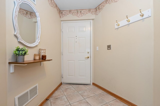 doorway to outside featuring light tile patterned flooring