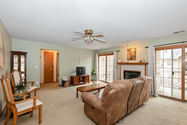 living room with ceiling fan and light colored carpet