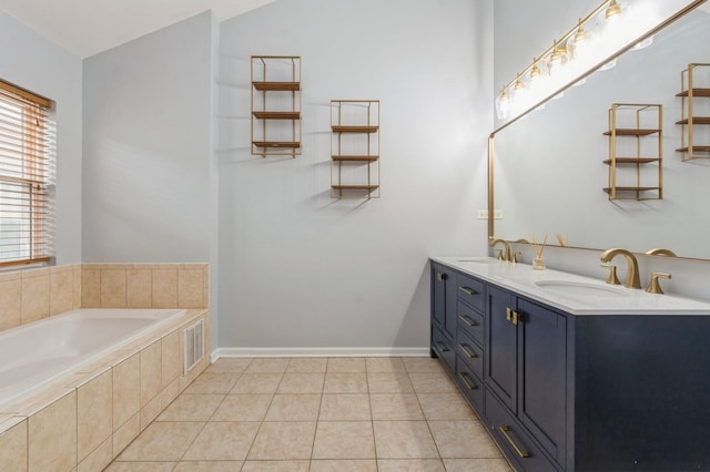 full bath featuring a garden tub, tile patterned flooring, visible vents, and a sink