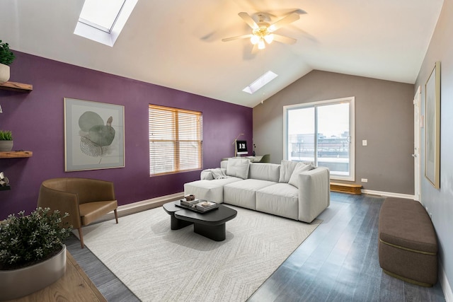 living area with dark wood-type flooring, a wealth of natural light, an accent wall, and vaulted ceiling with skylight