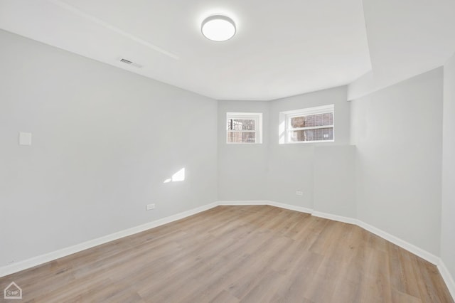 unfurnished room with light wood-type flooring