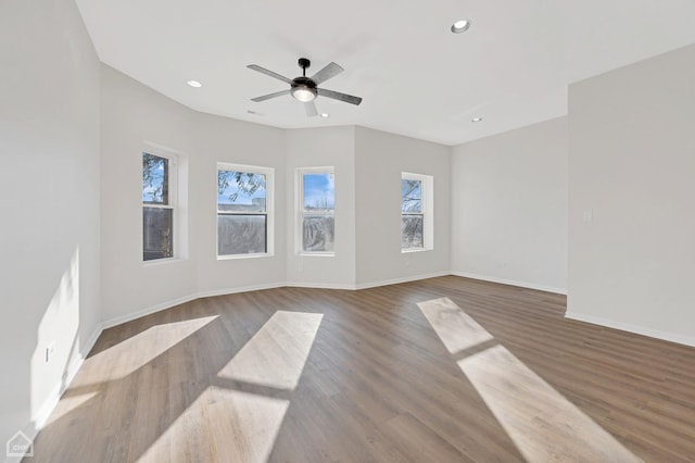 unfurnished living room with ceiling fan and dark hardwood / wood-style floors