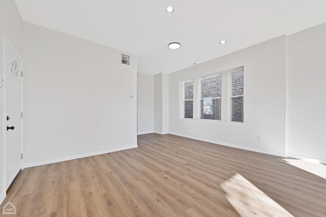 spare room with light wood-type flooring