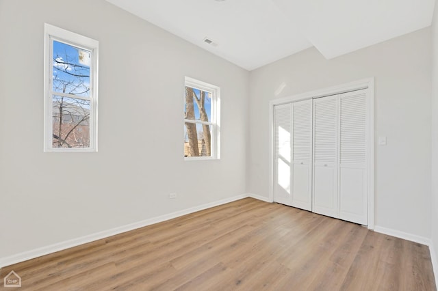 unfurnished bedroom featuring a closet and light hardwood / wood-style flooring