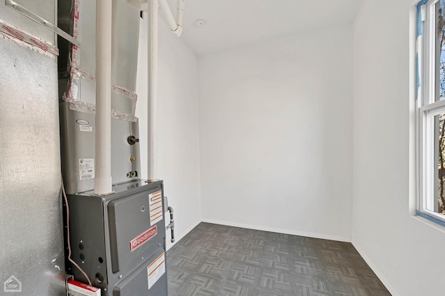 utility room featuring heating unit