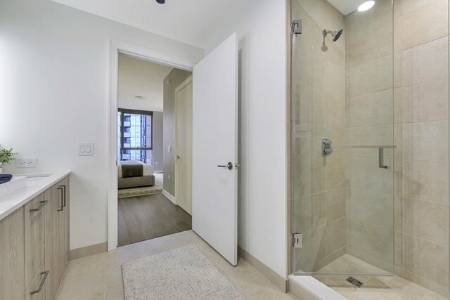 211 N Harbor Dr Unit 1909, Chicago, IL 60601 - bathroom featuring vanity, an enclosed shower, and tile patterned floors