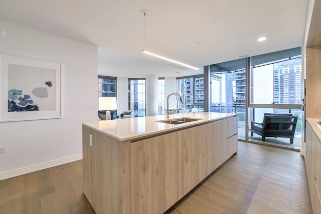211 N Harbor Dr Unit 1909, Chicago, IL 60601 - kitchen with expansive windows, light brown cabinetry, sink, and a center island with sink
