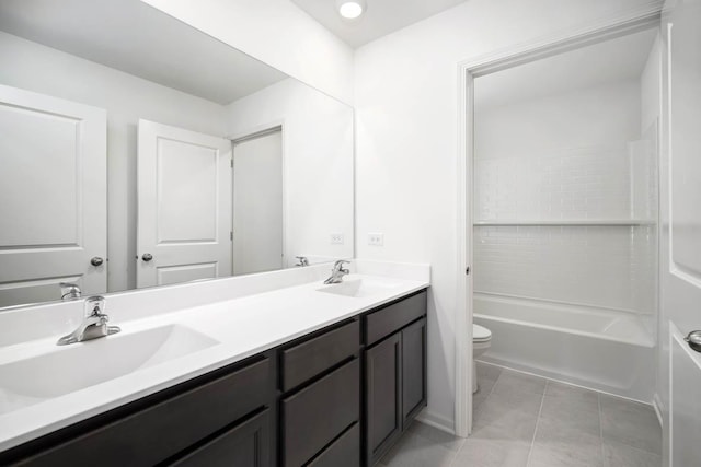 full bathroom featuring vanity, tiled shower / bath, tile patterned flooring, and toilet