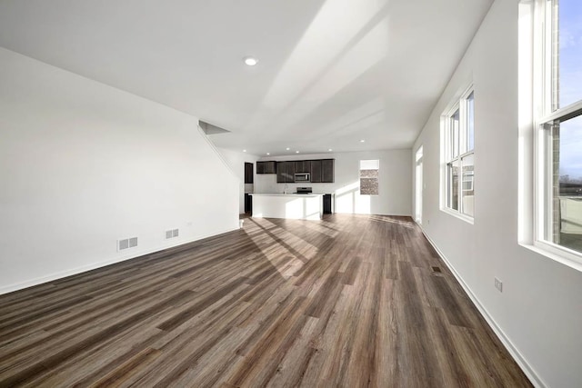 unfurnished living room with dark hardwood / wood-style flooring